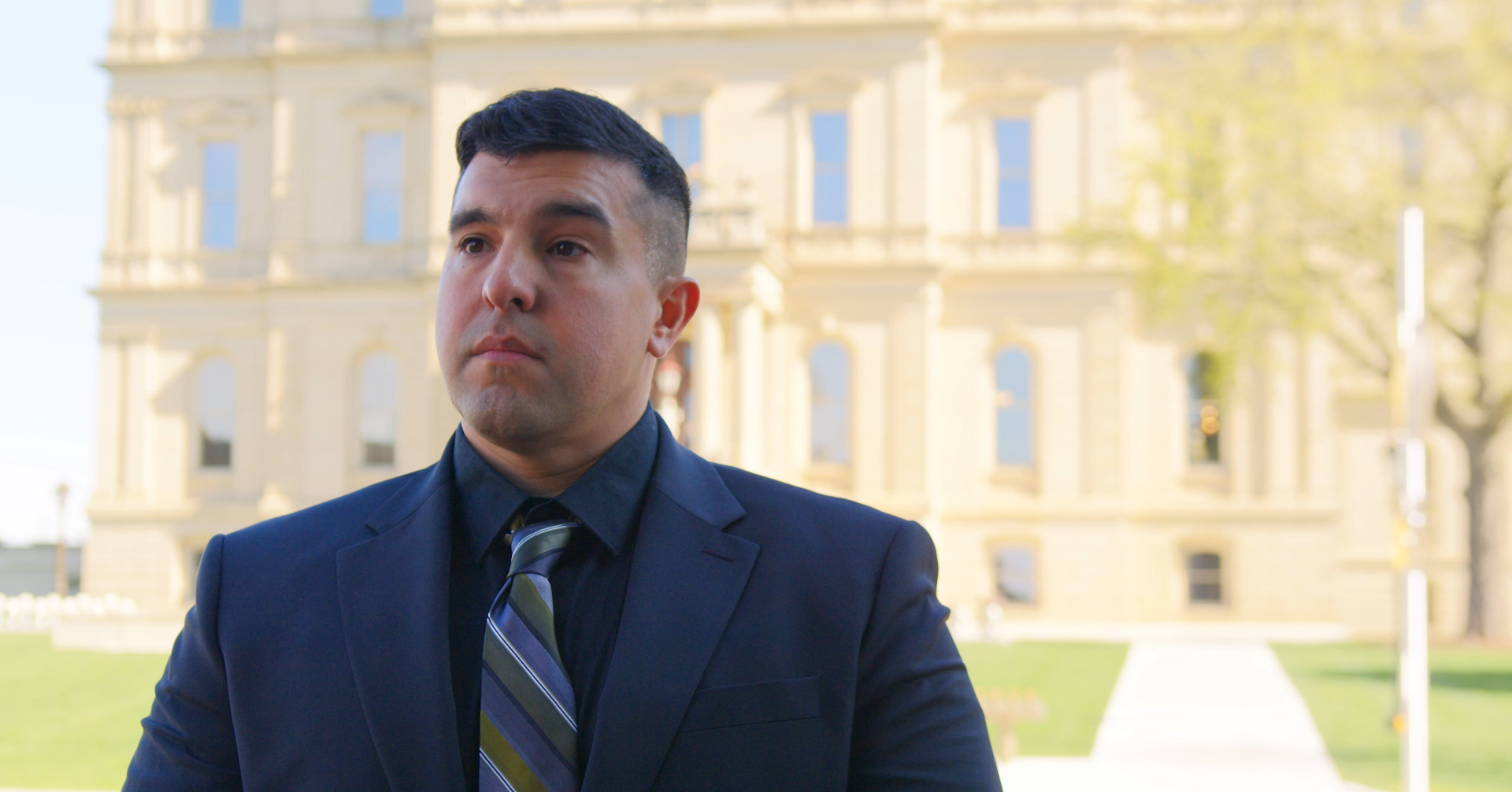 Richard Cardenas standing in front of the Michigan State Capitol